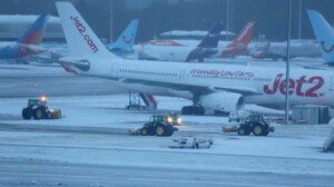 Flights and trains cancelled as snow hits UK