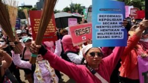 Indonesian women protest with brooms, demand police reforms