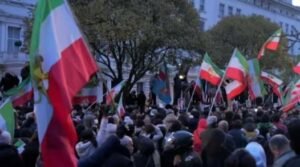 Protester climbs onto balcony of Iranian embassy in London